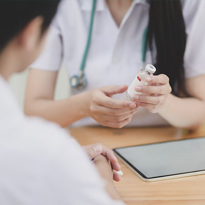 Fotografía de una doctora entregando un medicamento a un paciente